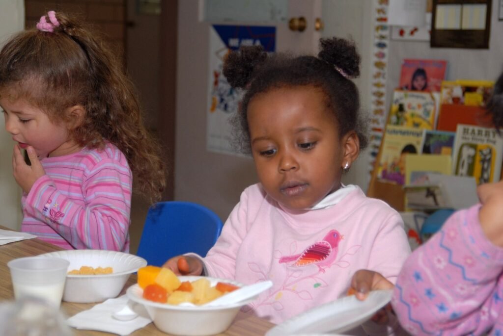 Youngsters at the Higher Horizons Day Care Center in Bailey Crossroads, VA., receive healthy food and snacks on October 25, 2006 under the U.S. Depart